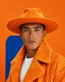 PrimeStyleAI fashion creator in an orange editorial look